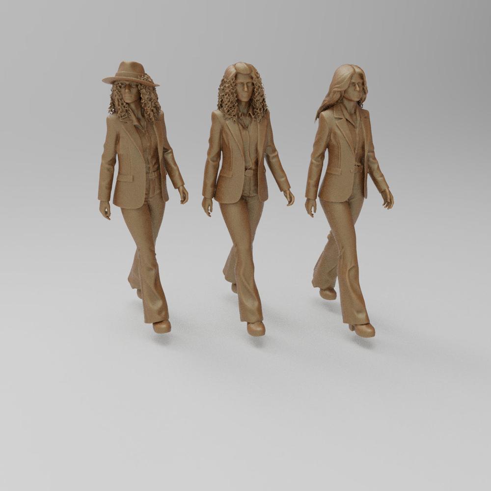 Three unpainted terracotta resin 3D printed figures of 1970s women in suits walking, for model dioramas.