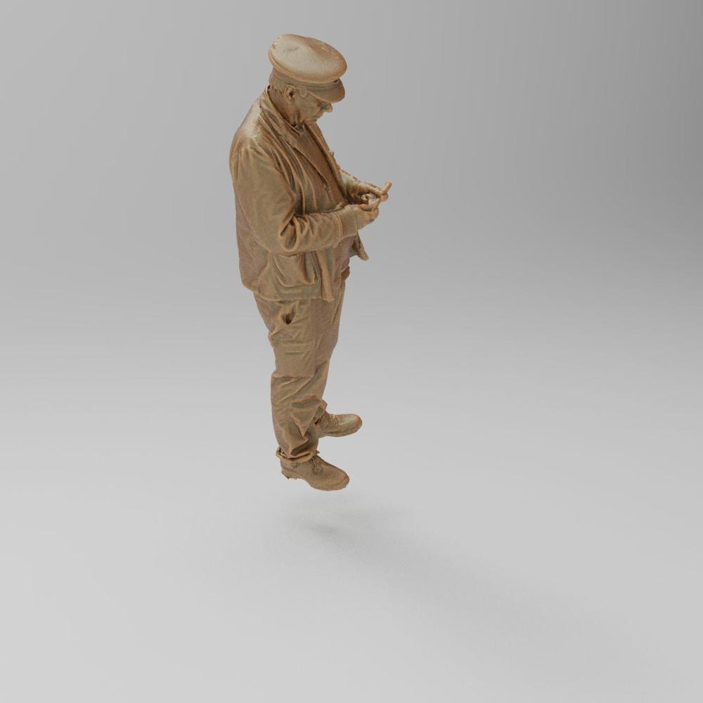 Unpainted terracotta-colored 3D printed miniature of a train driver wearing a cap and jacket, for model railways.