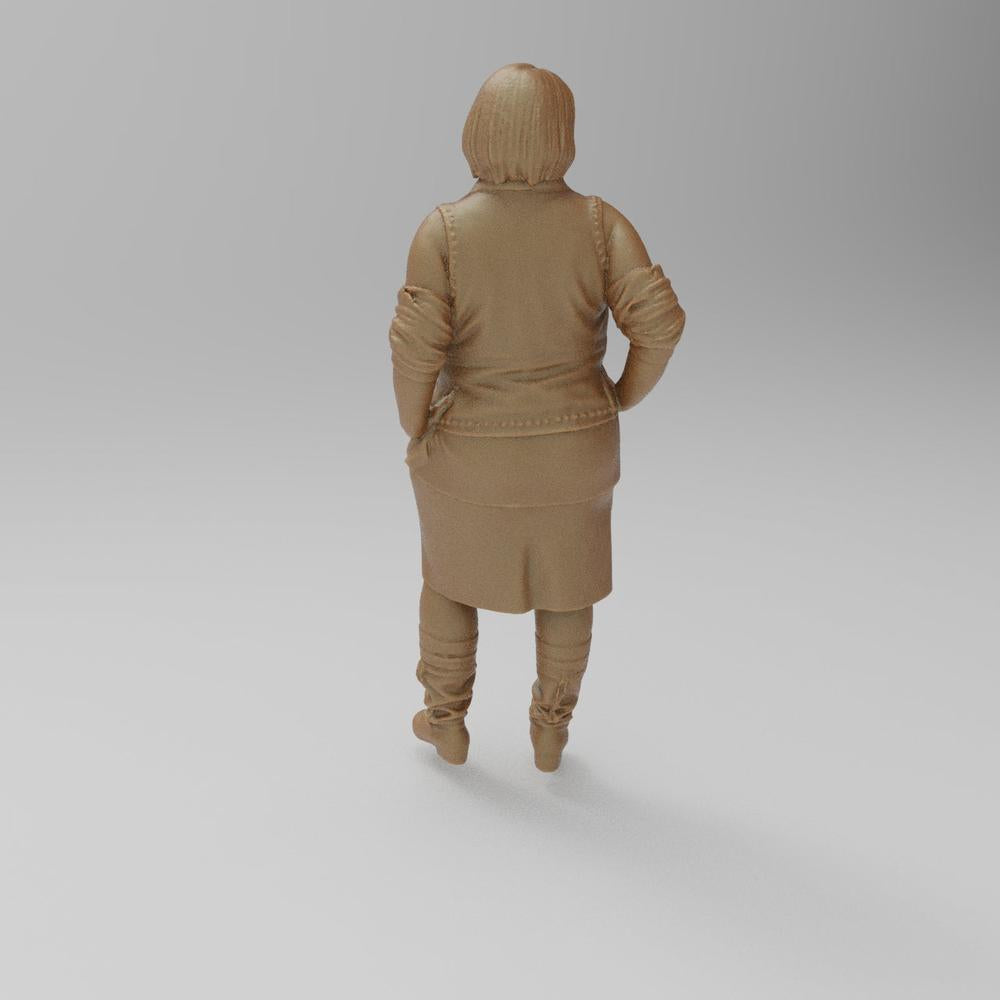 Unpainted terracotta-colored 3D resin scale model of a woman standing in a jacket, skirt, and boots, rear view.