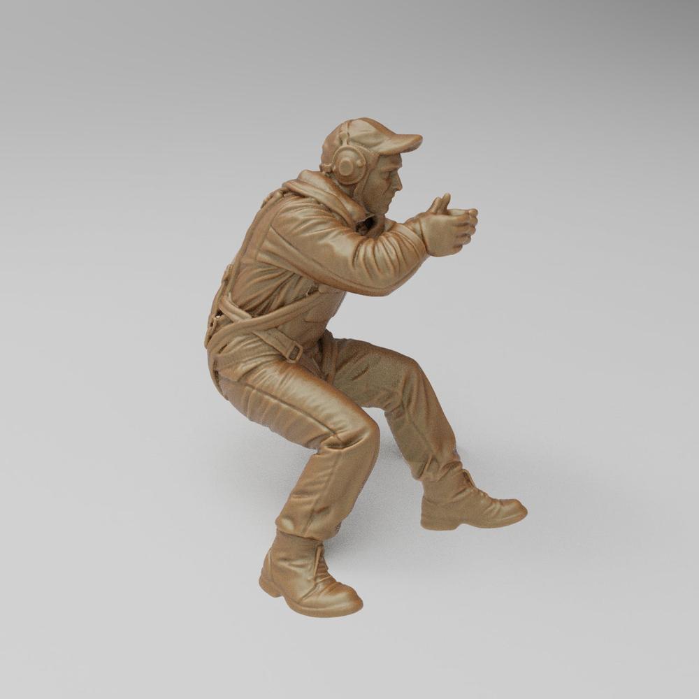 Unpainted terracotta-colored 3D printed resin model of a US WW2 bomber waist gunner in a seated firing position.