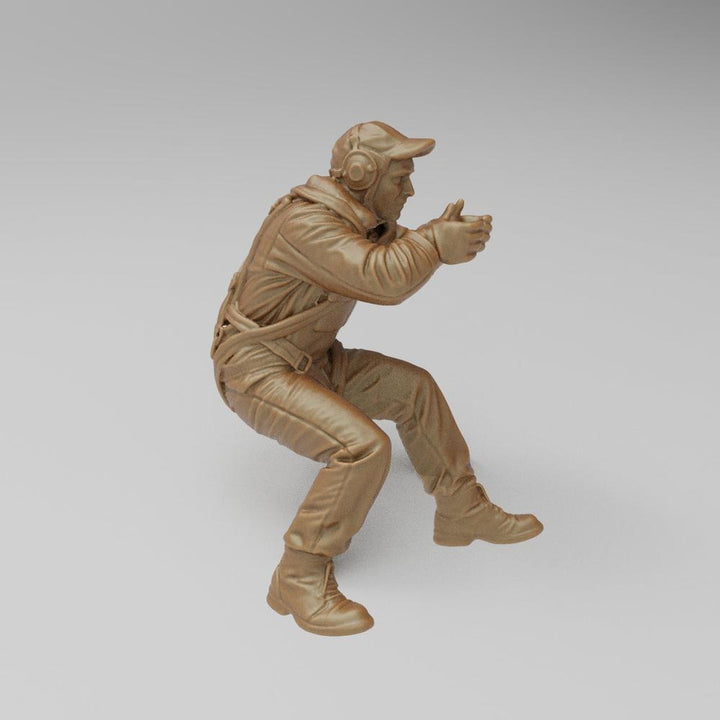Unpainted terracotta-colored 3D printed resin model of a US WW2 bomber waist gunner in a seated firing position.