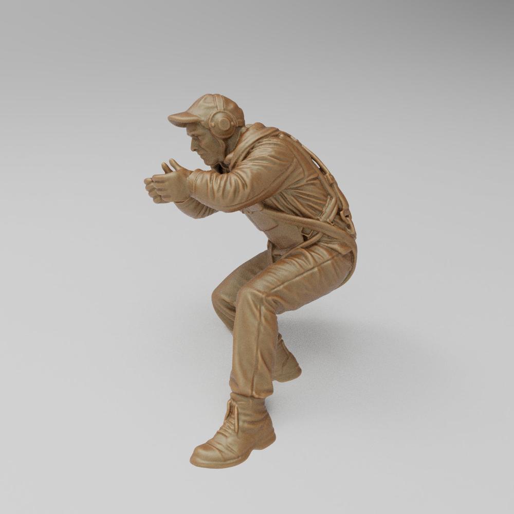 Unpainted 3D-printed resin miniature of a US WW2 bomber waist gunner in a crouching firing pose, clay-colored.