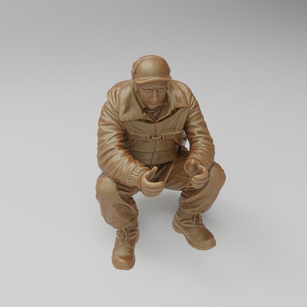 Unpainted clay-colored 3D printed model of a seated US WW2 bomber tail gunner in flight gear and cap.
