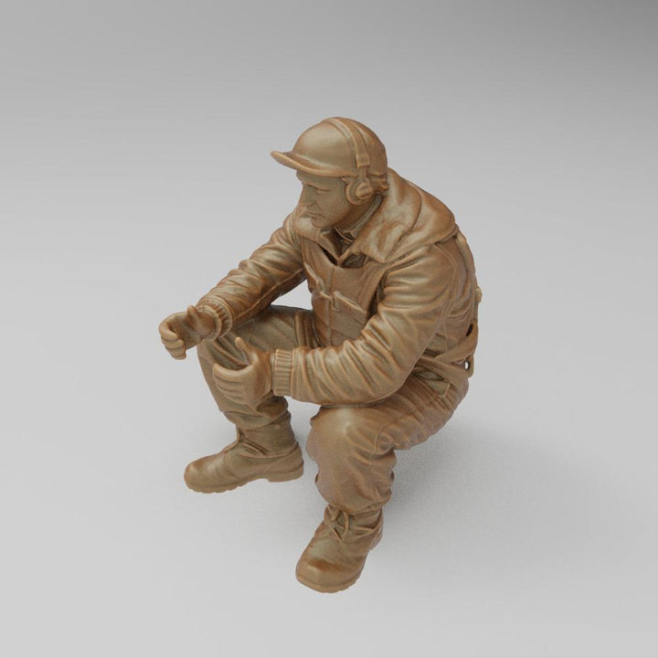 Unpainted 3D printed resin model of a WW2 US bomber tail gunner in a seated pose, featuring detailed flight gear.