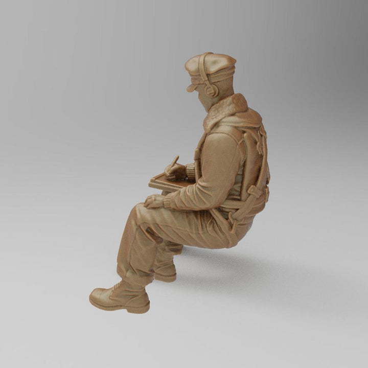 Unpainted 3D printed resin model of a seated WW2 bomber navigator writing on a clipboard, terracotta clay color.