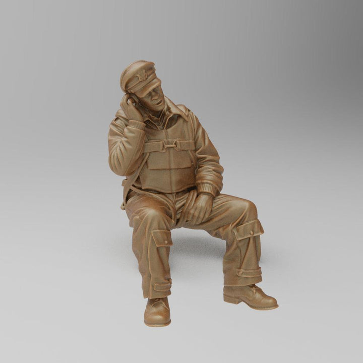 Unpainted terracotta resin 3D model of a seated WW2 bomber radio operator wearing a flight cap and uniform.