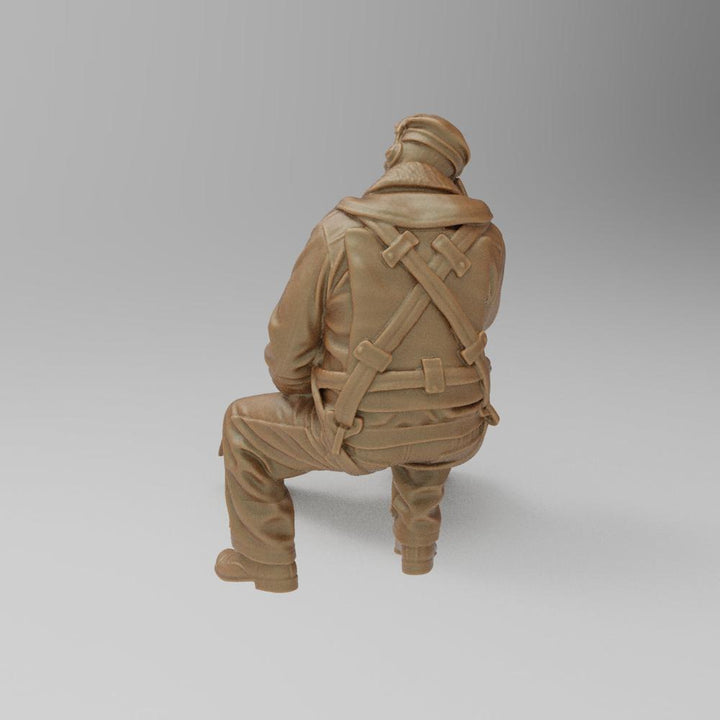 Unpainted 3D printed resin model of a seated WW2 bomber radio operator in terracotta clay color.