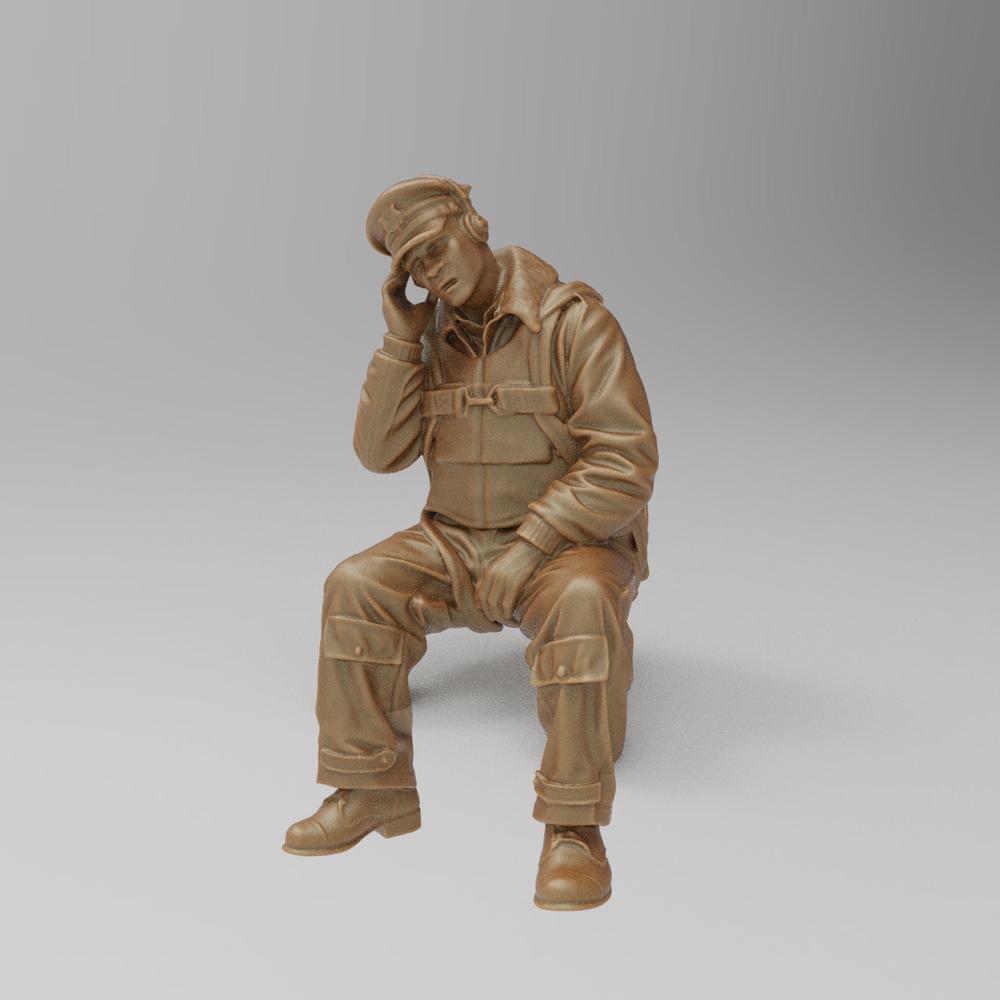 Unpainted 3D printed resin miniature of a seated WW2 US bomber radio operator wearing a headset and flight gear.