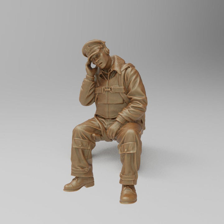 Unpainted 3D printed resin miniature of a seated WW2 US bomber radio operator wearing a headset and flight gear.