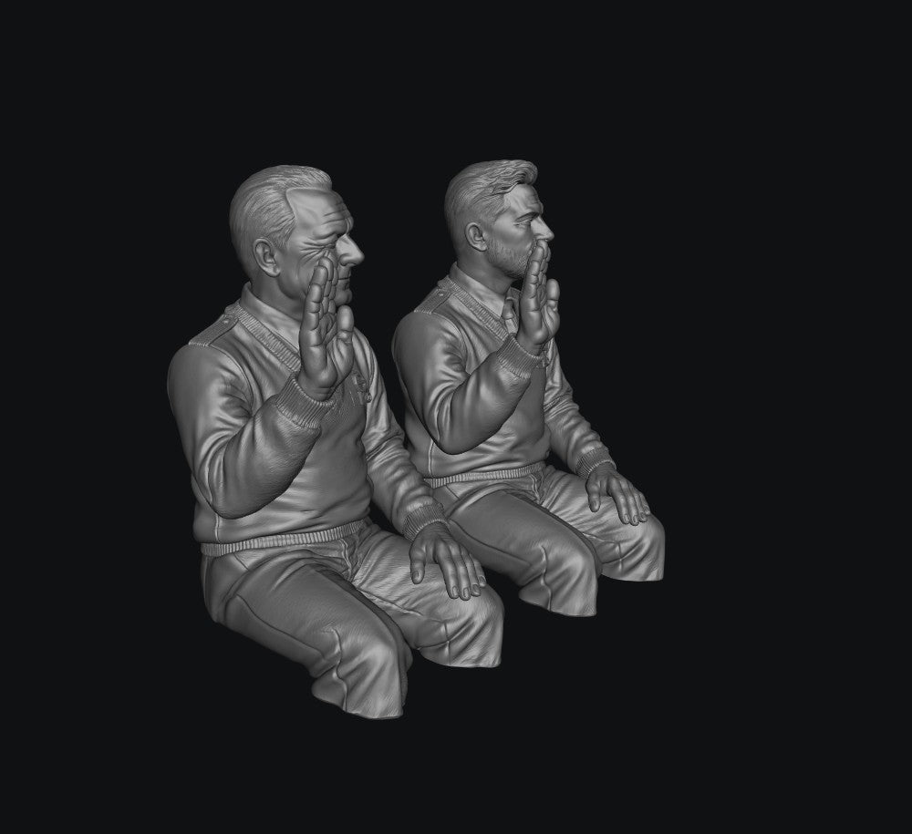 Two unpainted grey resin 3D-printed male bus driver figures in seated poses with raised hands.