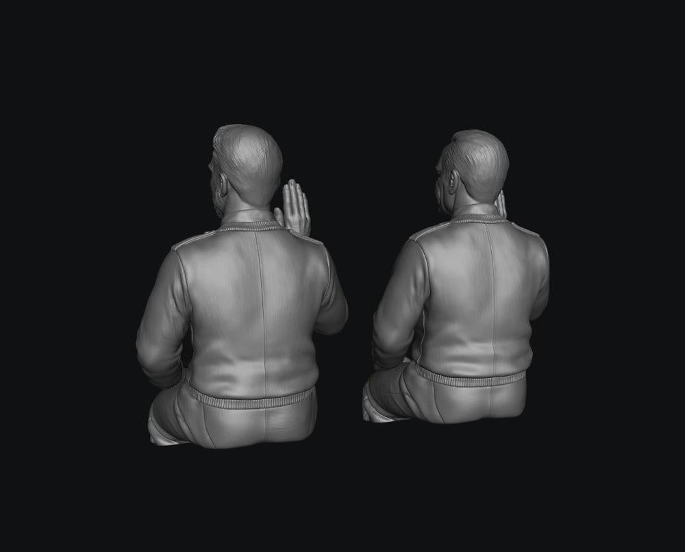 Two unpainted grey 3D-printed male bus driver figures in seated poses, shown from behind on a black background.