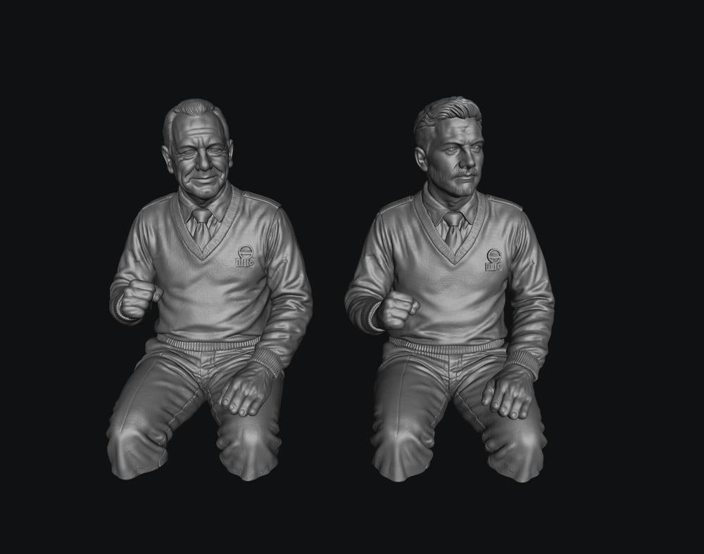 Two unpainted grey 3D-printed resin male bus driver figures in seated poses, wearing V-neck sweaters and ties.