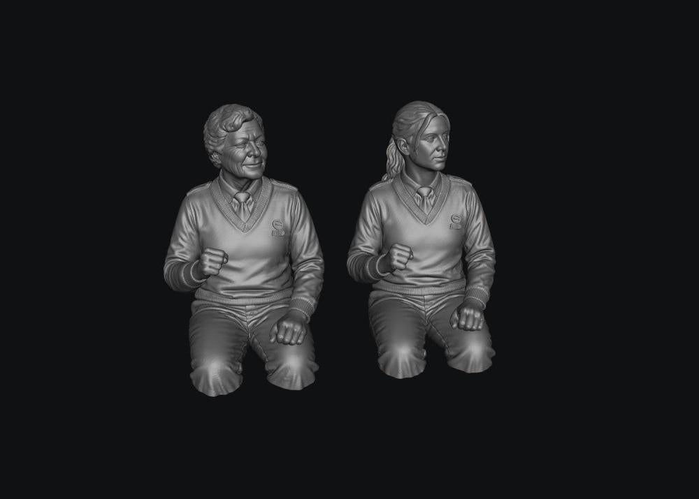 Two unpainted grey resin 3D-printed female bus driver figures in uniform, shown from the waist up in a seated pose.