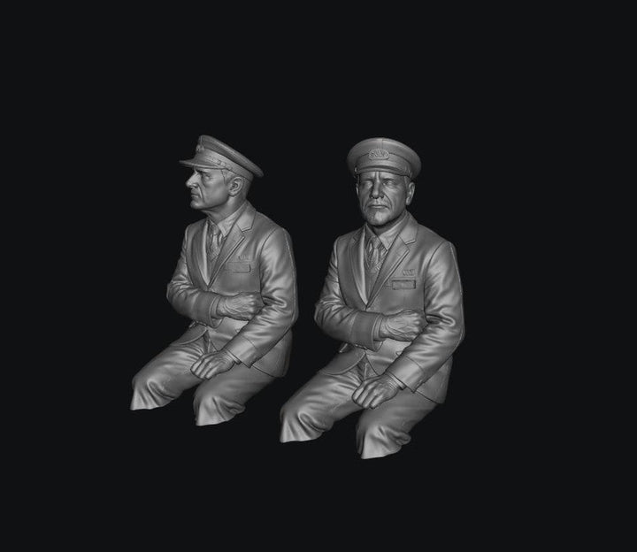 Two unpainted grey resin scale model train drivers wearing peaked caps and formal uniforms, shown in a 3D digital render.