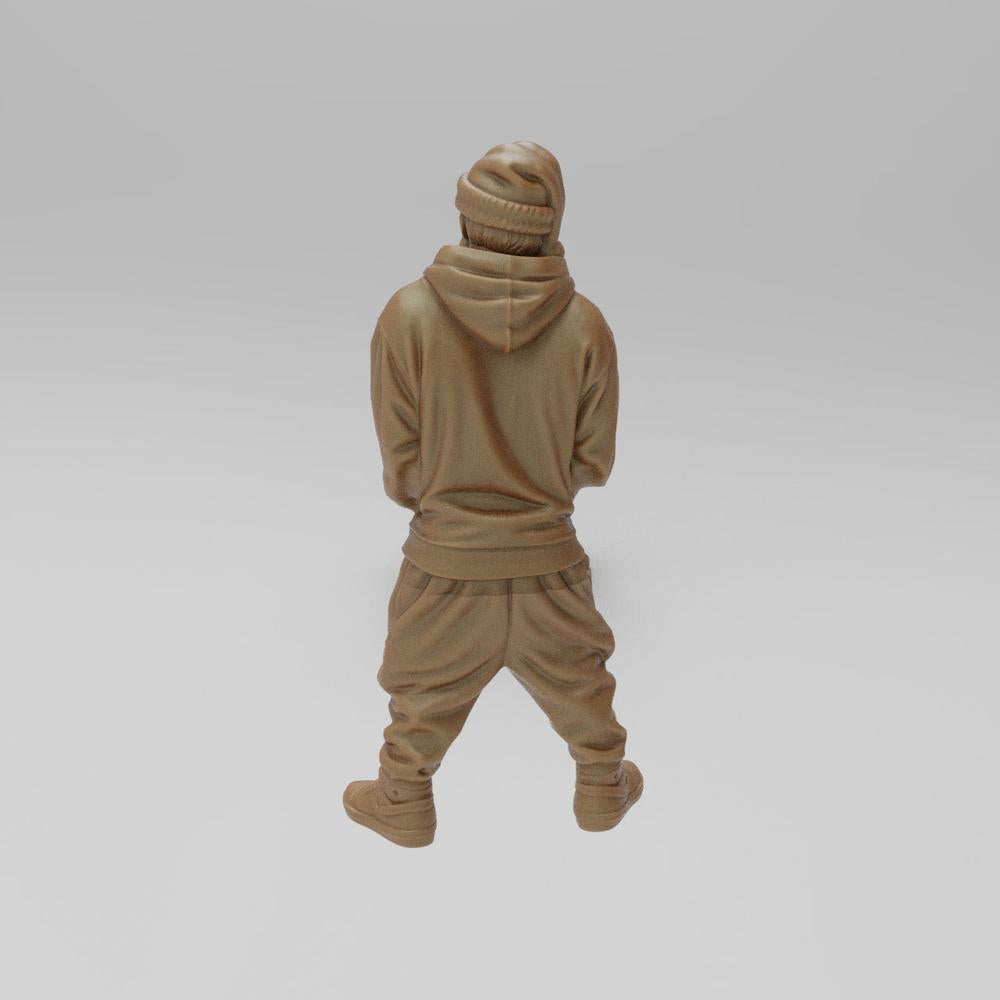Unpainted terracotta resin 3D model of a sporty Santa figure wearing a hoodie, beanie, and sneakers, seen from behind.