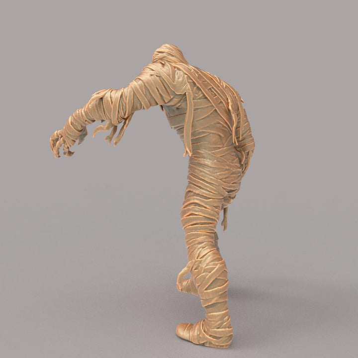 Unpainted terracotta-colored 3D resin model of a mummy figure wrapped in bandages in a reaching pose.