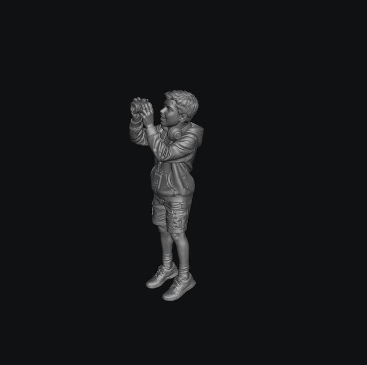 WOSC011 - Young Boy with a Camera