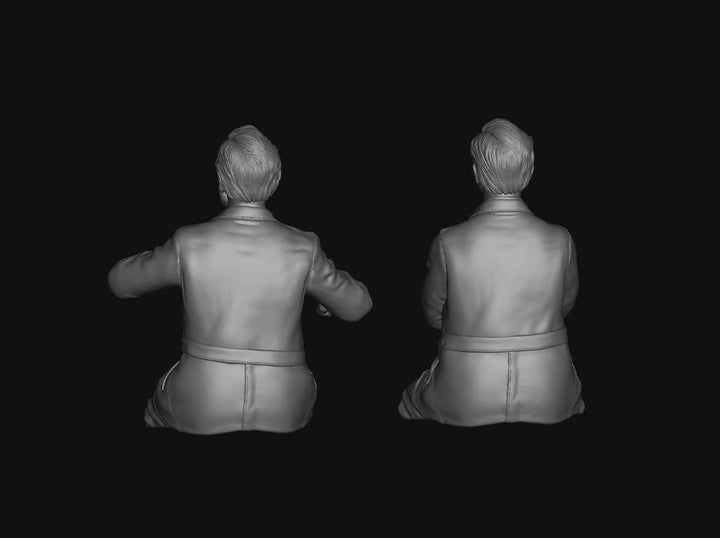 Two unpainted grey 3D resin model figures of early British Rail train crew members viewed from behind.