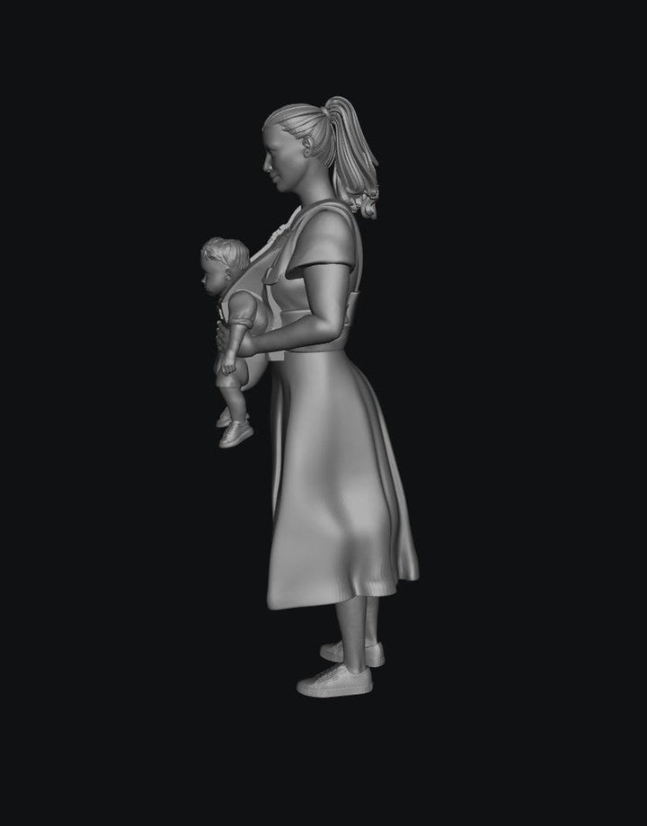 Unpainted grey 3D resin scale model of a woman in a dress carrying a baby in a front-facing carrier.