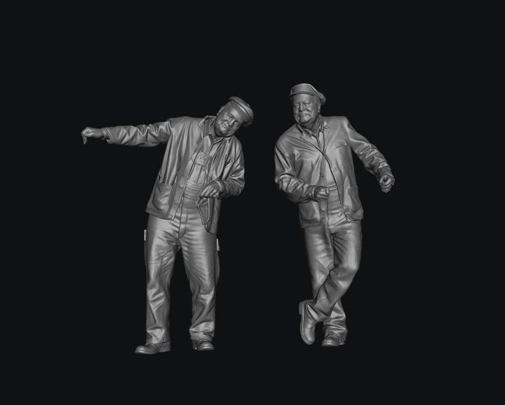 Two unpainted grey 3D-printed resin scale model figures of steam and diesel train engine drivers in caps.