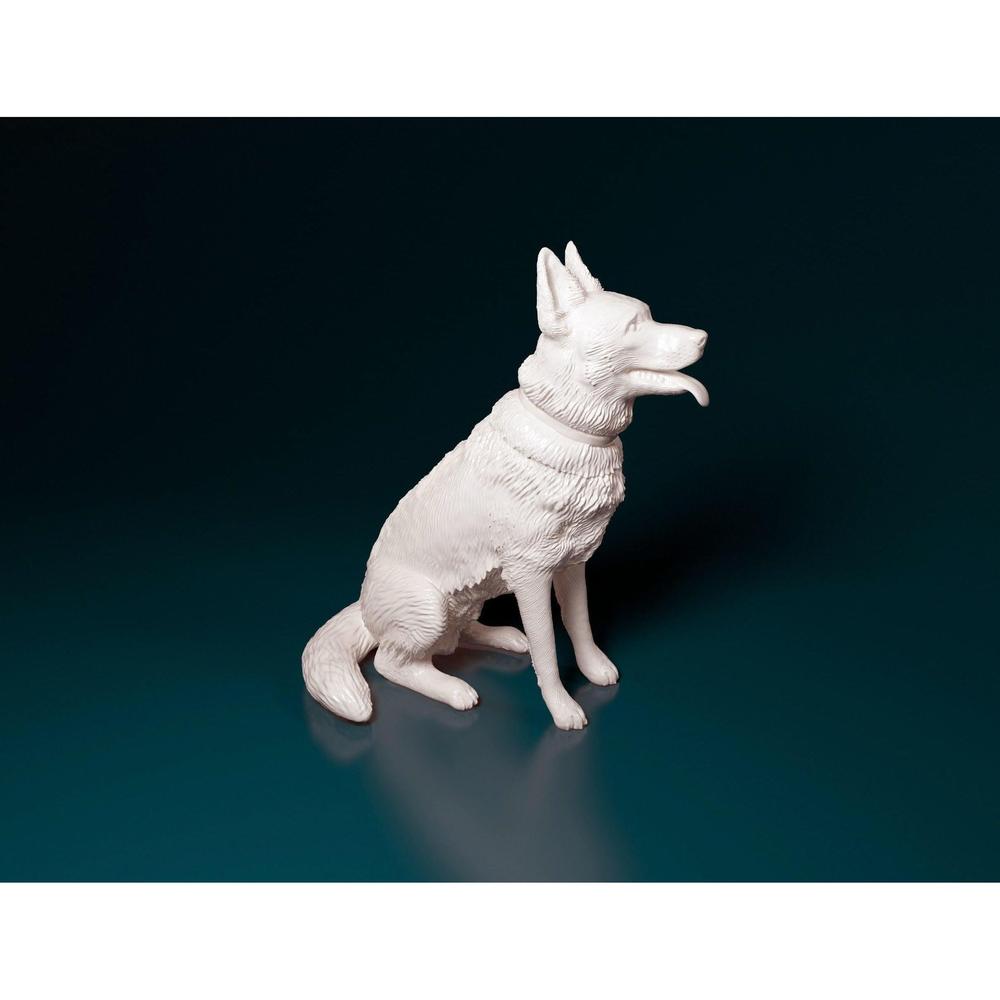 Unpainted 3D-printed resin miniature of a sitting German Shepherd with detailed fur texture on a dark background.
