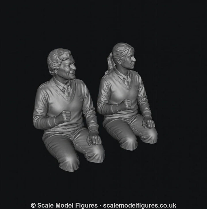 Two unpainted grey resin 3D-printed scale model figures of female bus drivers wearing V-neck sweaters and shirts.