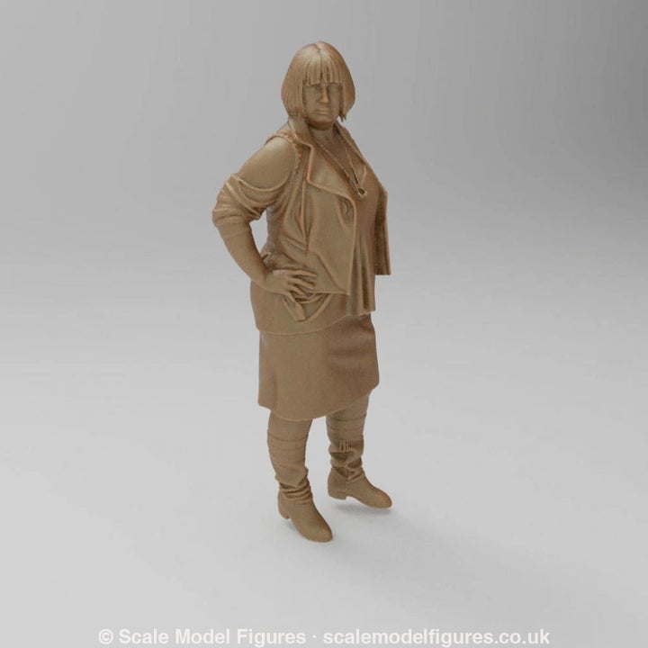 Unpainted terracotta-colored 3D resin model of a woman in a jacket, skirt, and boots for dioramas and model railways.